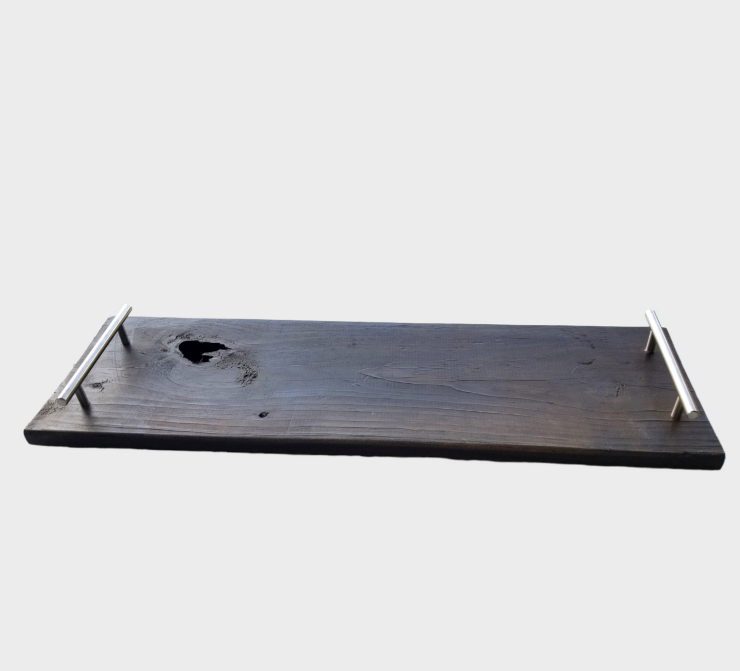 This rustic farmhouse wooden tray is perfect for displaying your favorite decorative pieces. Its distressed dark brown finish adds a vintage charm to any room. Crafted from high-quality wood, its sturdy construction ensures long-lasting use. The tray's handles make it easy to transport from room to room. Perfect for adding a touch of country style to your home, this distressed wooden tray is a classic addition to any decor. Shipping to the USA, Canada, Jamaica, Caribbean and UK.