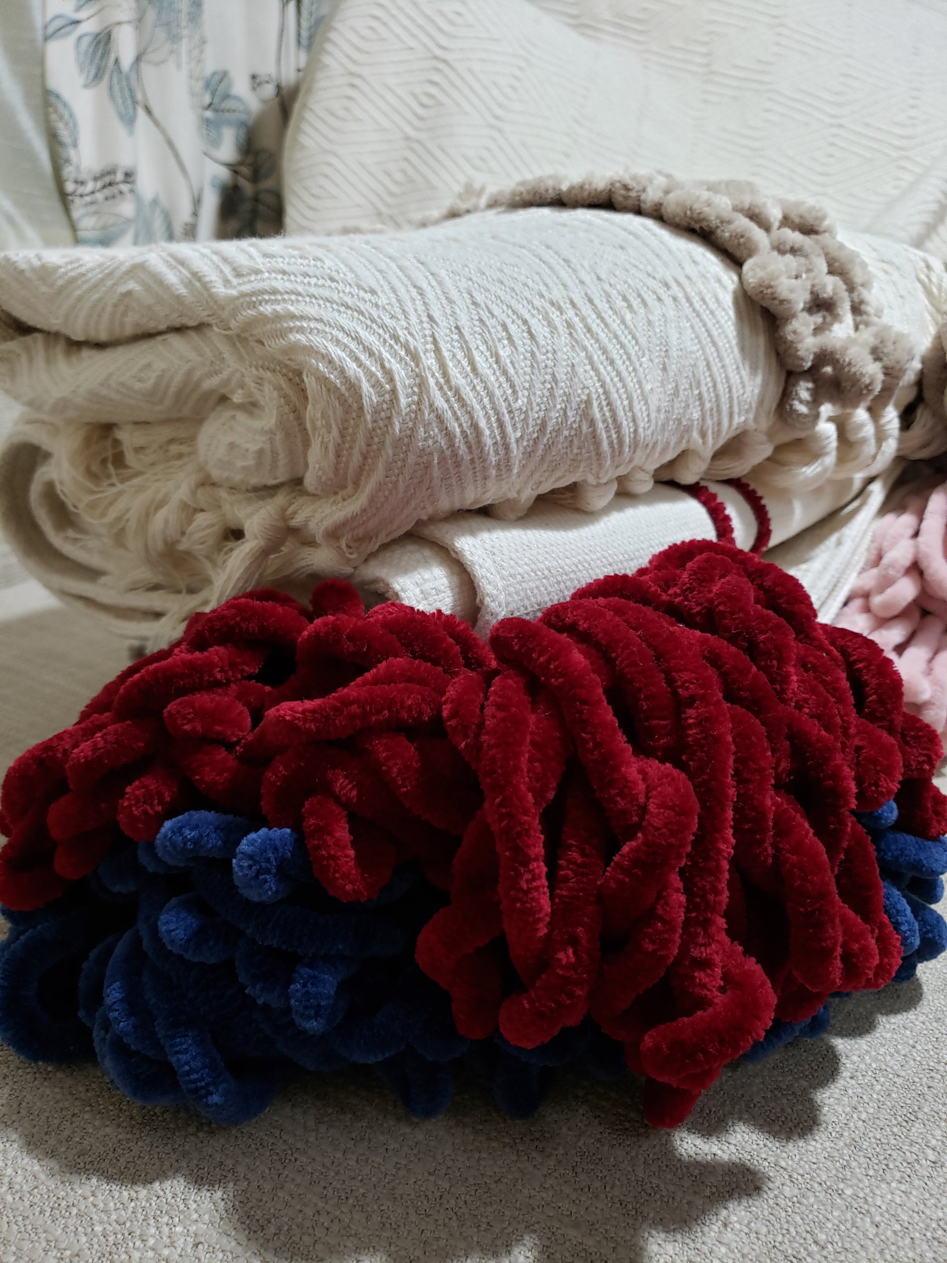 Elevate your bedroom with the Reneecé Ivory and Ruby Red Bed Runner. Made from designer fabric, this luxury reversible blanket features calming ivory tones and bold ruby red tassels for a touch of sophistication. Handmade with high-end quality and durability, this Fiona Kimberly Design piece adds both style and comfort with its extra soft and cozy reversible design. Shop now for this limited edition piece!