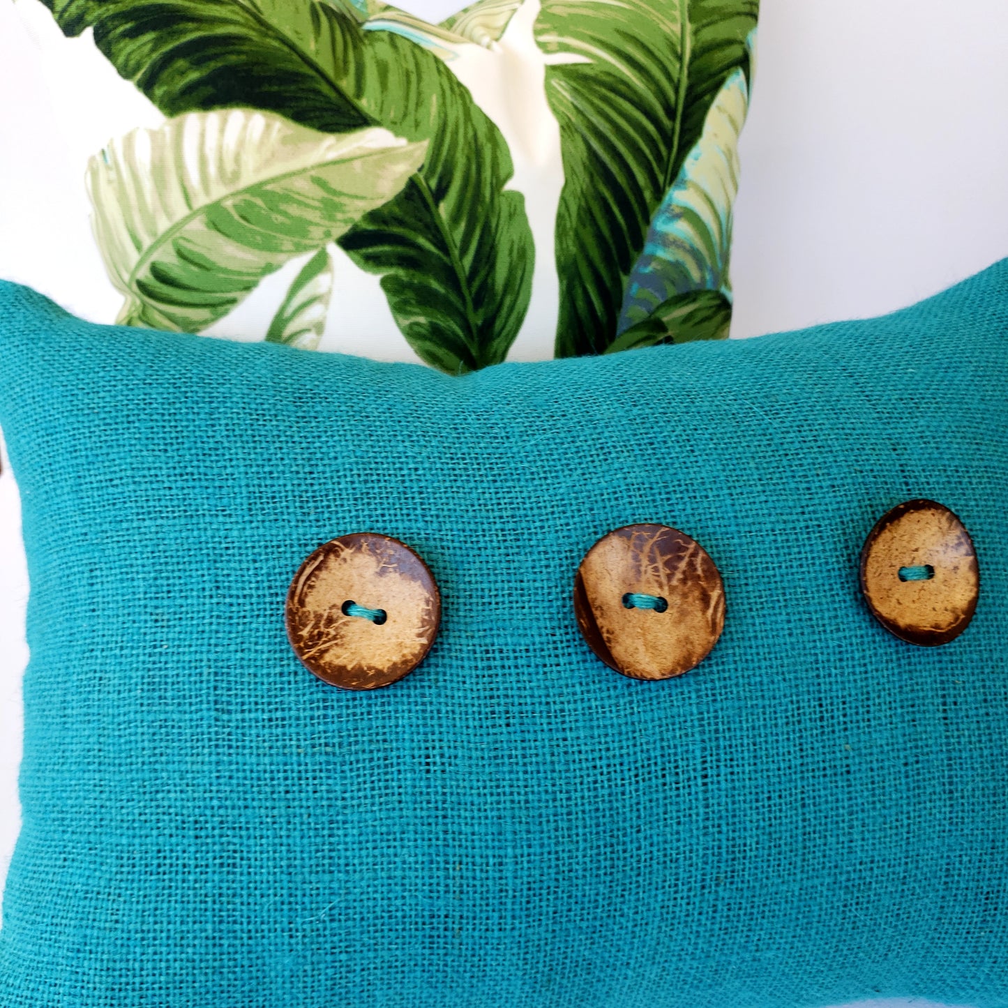 Introducing a luxurious addition to your home decor - the Coastal Teal Burlap Decorative Pillow Cover. Made from the finest Teal burlap fabric, accented with large coconut buttons and meticulously lined and double stitched by designer Fiona Kimberly. Transform your space with a touch of boho coastal elegance.
Lumbar pillow